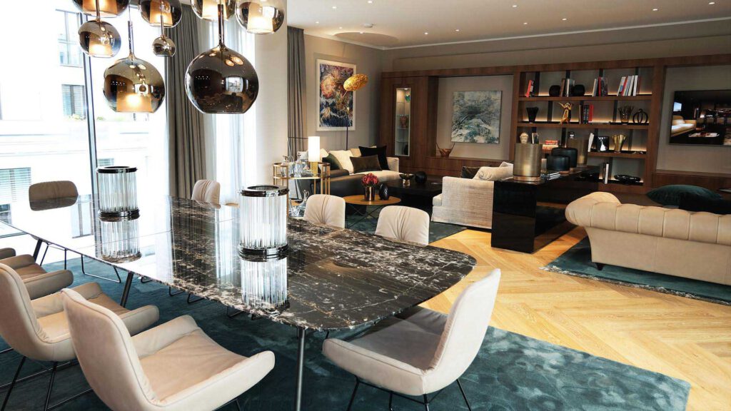 Dining area in Nº3 Schinkelplatz in Berlin-Mitte with large marble table and view into the living area