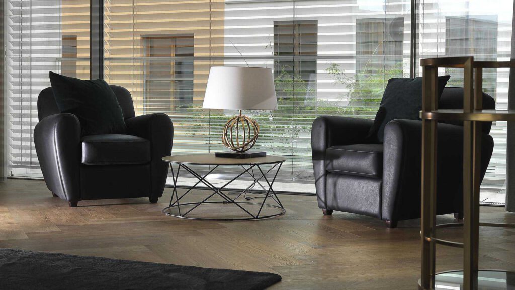 Lounge area at Nº3 Schinkelplatz in Berlin-Mitte with armchairs and views through floor-to-ceiling windows