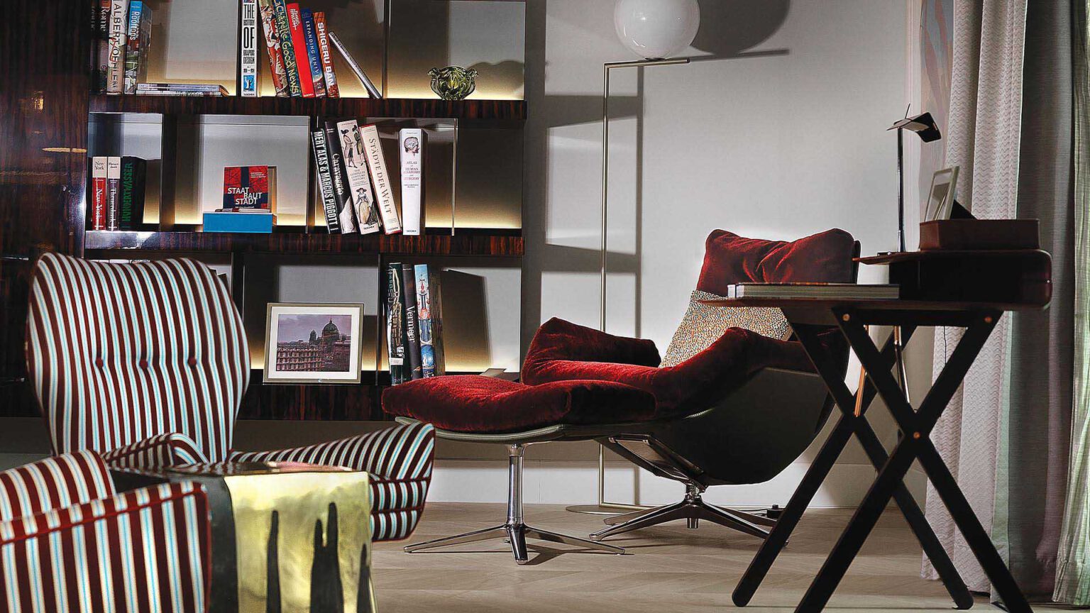 Reading and working area at Nº3 Schinkelplatz in Berlin-Mitte with designer chair and integrated library