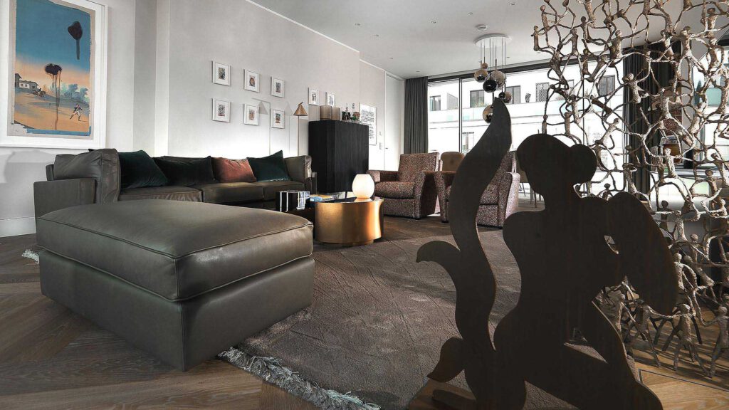 Living area at Nº3 Schinkelplatz in Berlin-Mitte with designer sofa, art objects and open interior design