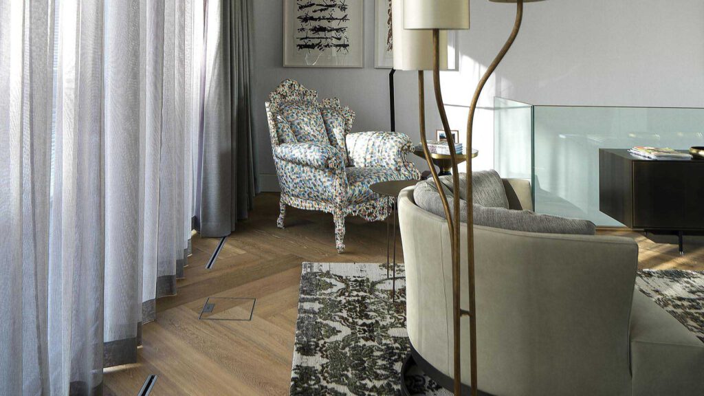 Seating area at Nº3 Schinkelplatz in Berlin-Mitte with upholstered armchairs and textile materials