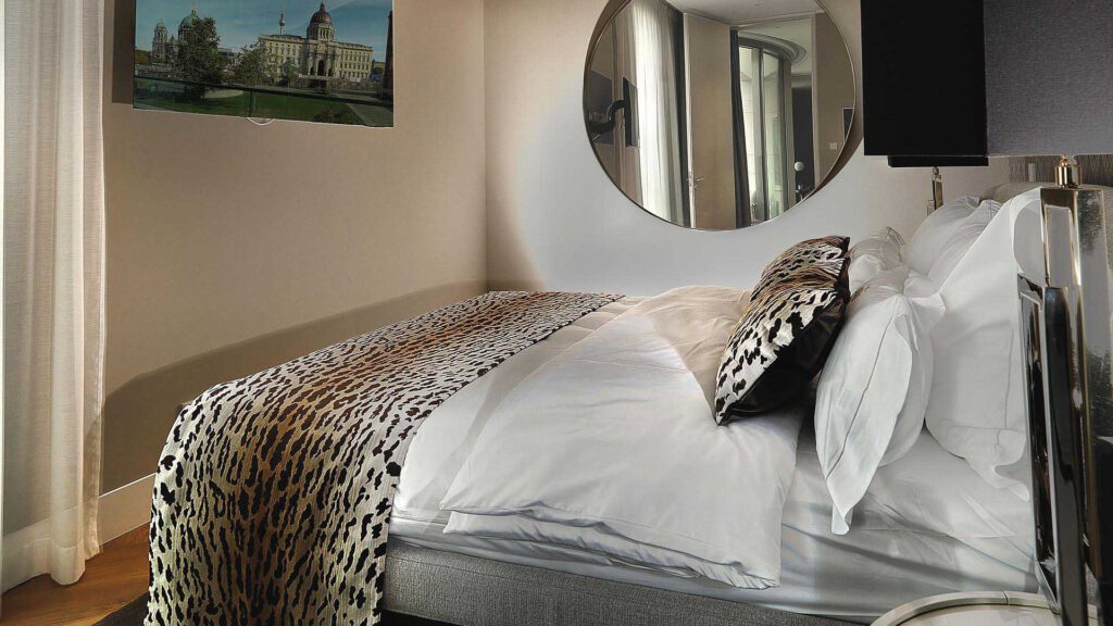 Bedroom at Nº3 Schinkelplatz in Berlin-Mitte with a view of the Berlin City Palace and floor-to-ceiling windows