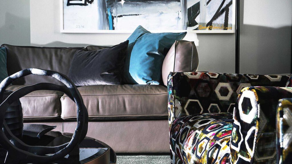 Living area at Nº3 Schinkelplatz in Berlin-Mitte with designer sofa, artwork and patterned armchair