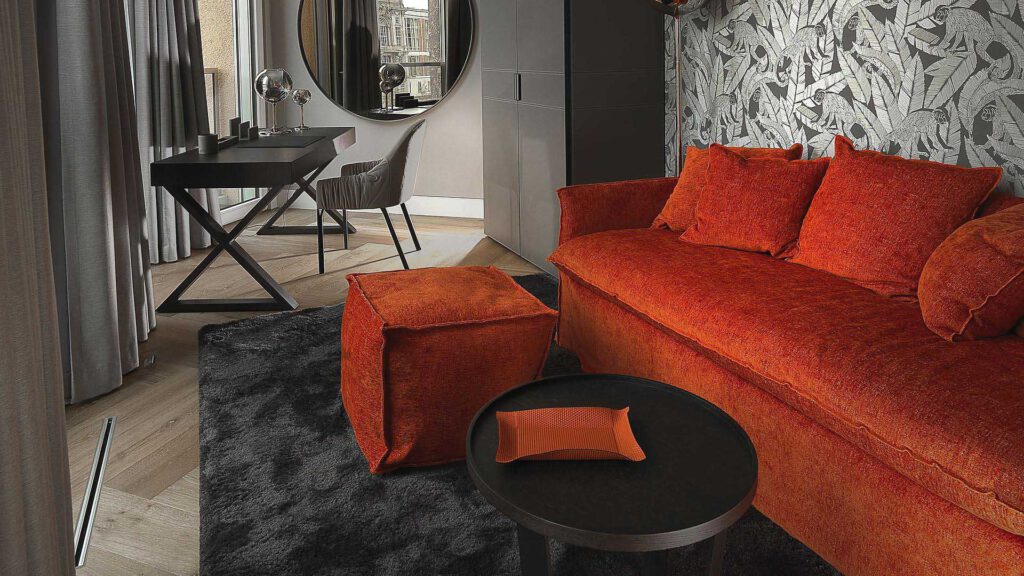 Living and working area at Nº3 Schinkelplatz in Berlin-Mitte with sofa, desk and view of the city