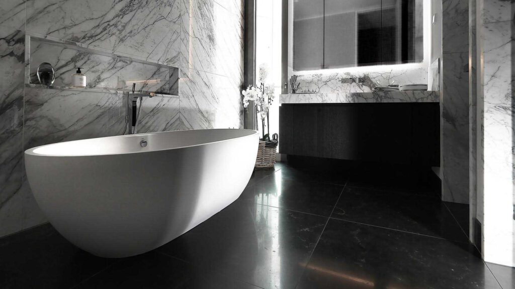 Bathroom at Nº3 Schinkelplatz in Berlin-Mitte with free-standing bathtub and natural stone