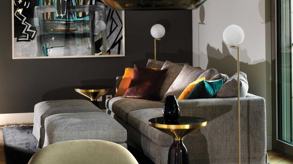 Living area at Nº3 Schinkelplatz in Berlin-Mitte with designer sofa, artwork and brass elements