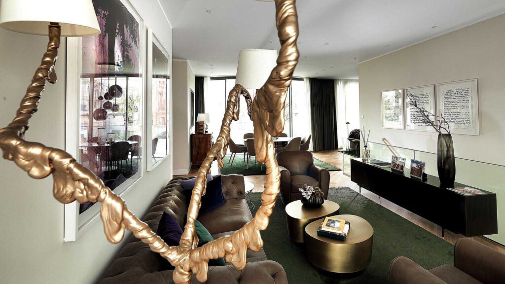 Living area at Nº3 Schinkelplatz in Berlin-Mitte with designer sofa, art object and stylish materials