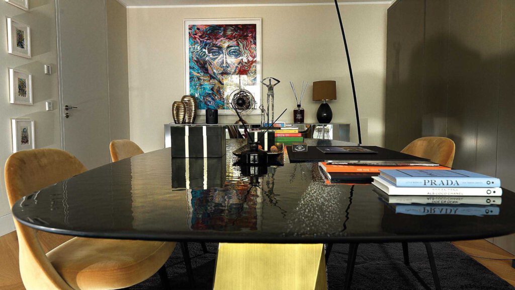 Work and dining area at Nº3 Schinkelplatz in Berlin-Mitte with design table, books and art